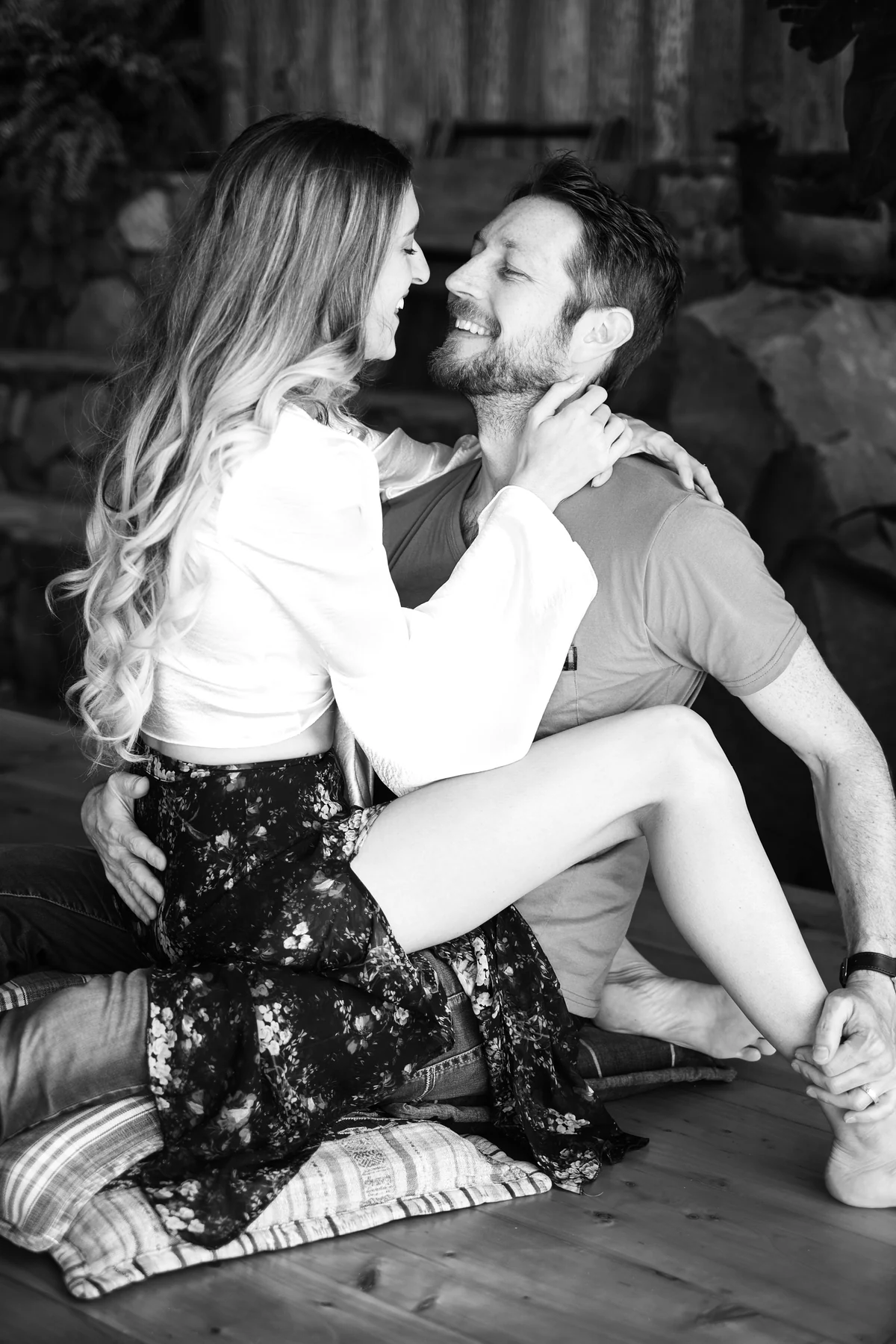 Marissa and Eric smiling at one another in a close embrace, photographed in black and white.
